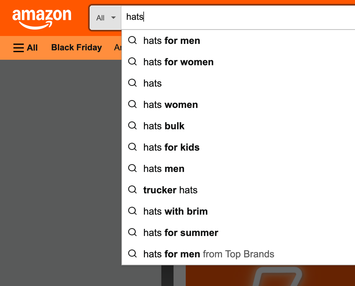 Amazon search box with autocomplete dropdown showing long-tail product suggestions like "hats for men" and "hats for women"